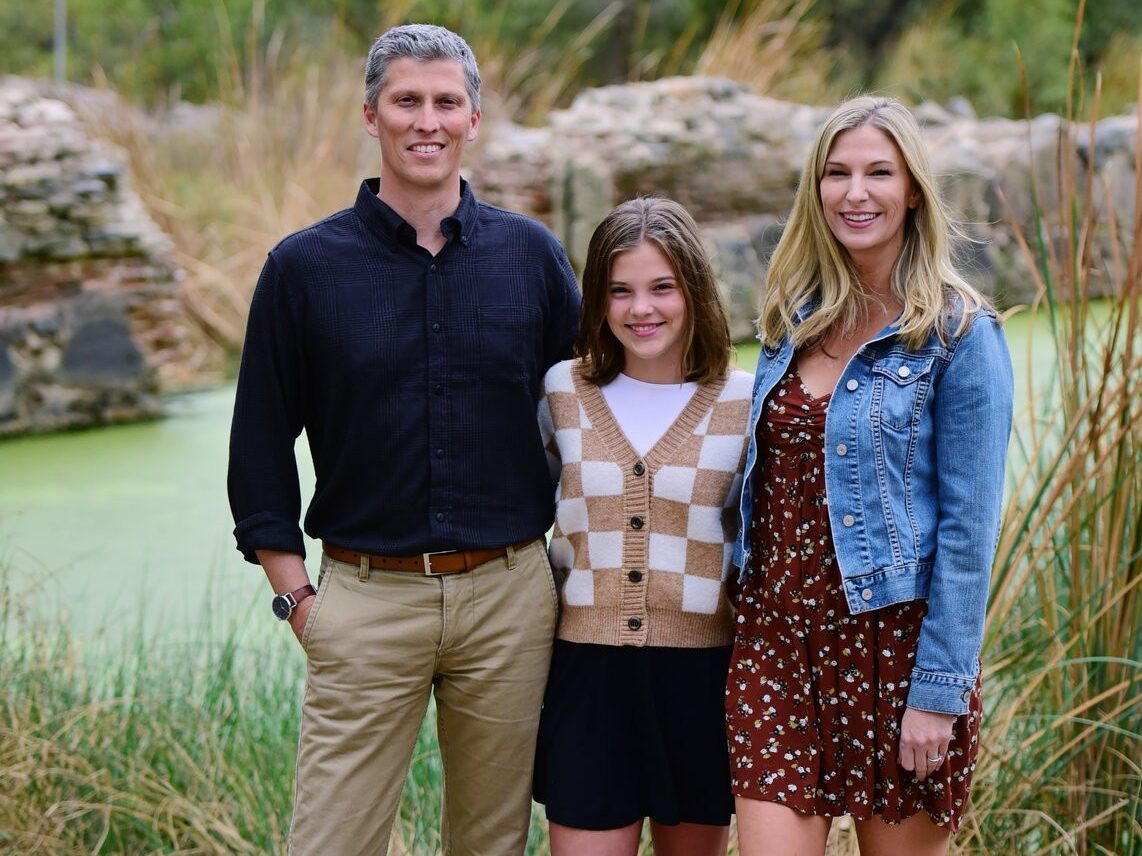 Casey Williams with her husband and daughter outdoors